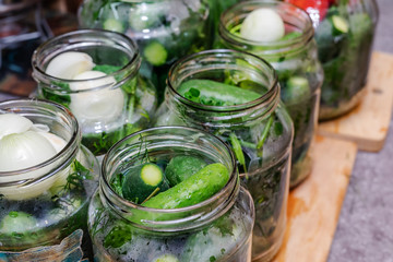 Pickles with herbs and spices. On a wooden background.