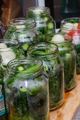 Pickles with herbs and spices. On a wooden background.