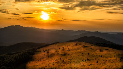 Stunning sunset in the mountains. Orange sky and mountains silhouettes. Carpathian Mountains. Bieszczady. Poland © Szymon Bartosz