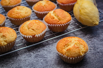 Homemade durian cupcakes on rock table.