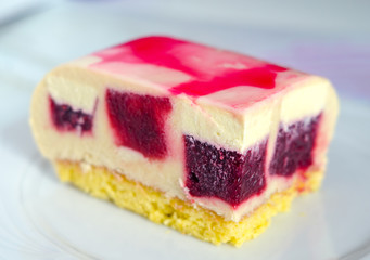  Mousse cake with cherry filling with glossy glaze and red stains