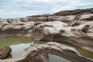Fototapeta na wymiar River Island. Rocks from water erosion. 