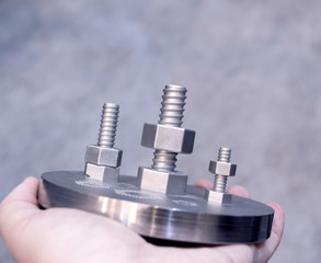Man is holding object printed on metal 3d printer.