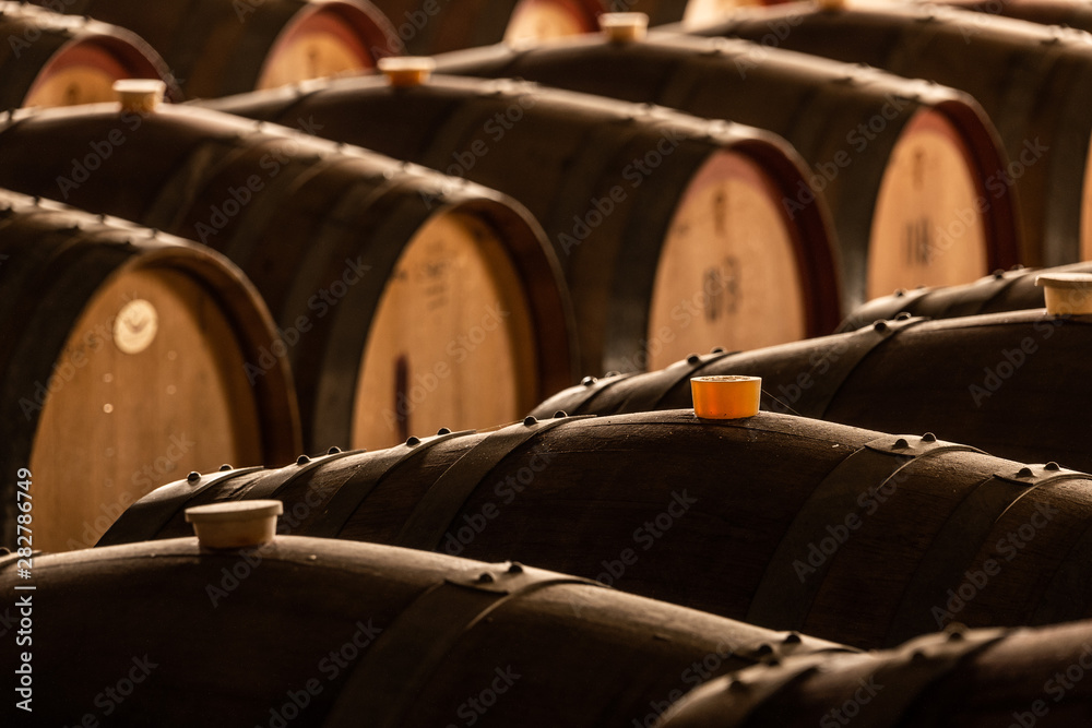 Wall mural old barrels of wine in a cellar