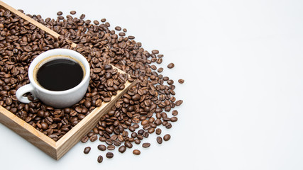 cup of coffee and beans on white background with text space