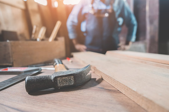 Carpenter on workplace in carpentry workshop.
