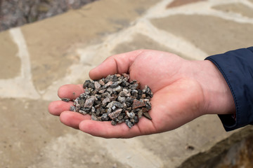 Hand holding small stones. Stones on incense.