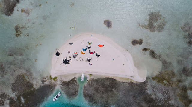 Aerial view of tropical island with people doing kitesurf and wind surf  in Los Roques Venezuela. Top Down Drone 