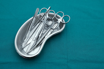 Basic surgical instrument scalpel forceps tweezers scissors in emesis or plus basin  on surgical...