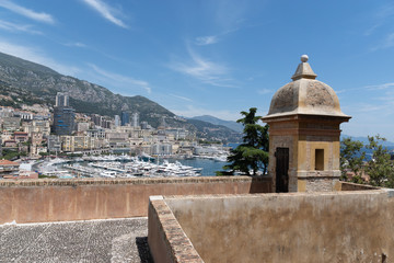 View from the top of mountain, in background is Port of Monaco, big ships and houses. Amazing landscape, blue sky and sea. Summer time.
