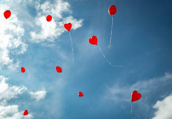 Red heart shaped Ballons blue sky