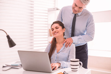 Man giving a massage to a colleague on the workplace