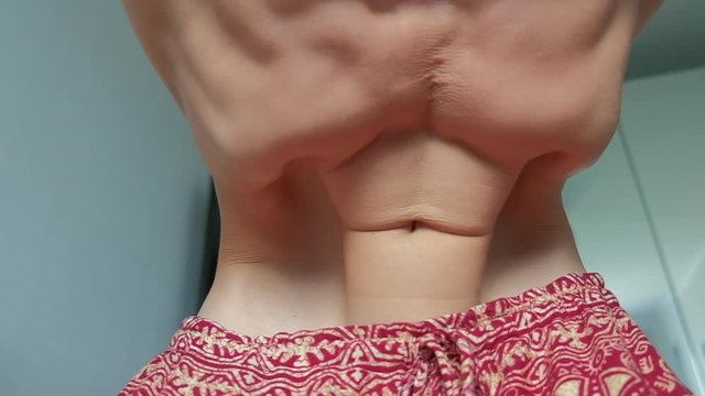 Young man with skinny and muscular body does Nauli Kriya cleaning exersice