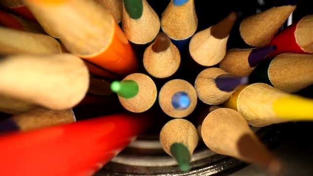Moving towards the tips of a jar of colored pencils. Medium focus shifts from tips to the bottom edge of the wood in focus. Using a wide angle probe lens to get a unique perspective.