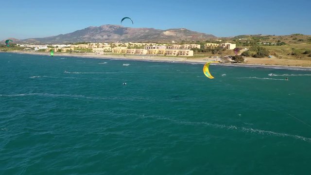 Kitesurfing in front of hotelbeach at Horizonbeach Resort in Kos - Greece 2019 near sunset. Lots of Kites in front of nice beach shot by drone with ND-PL filter in 4k 30frames.
