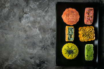 Mid Autumn Festival concept - yuebing monncakes on rustic background, top view