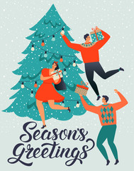 SEASONS GREETINGS. People young men and women decorate a Christmas tree.