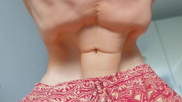 Loopable seamlees footage of the young man doing Nauli Kriya exercise - cleaning yoga exercise