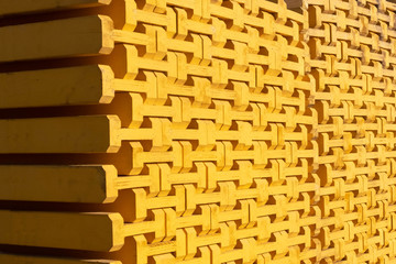 Yellow wooden piled formwork beams. Construction equipment
