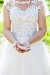 gold wedding rings in hands of newlyweds on wedding day