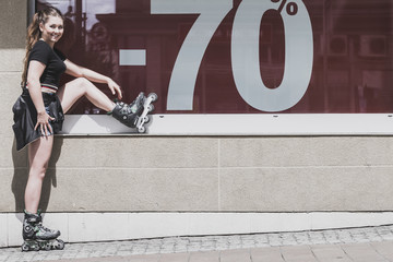Woman wearing roller skates next to sale