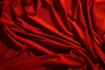 Background image of crumpled fabric. Red cloth