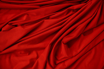Background image of crumpled fabric. Red cloth