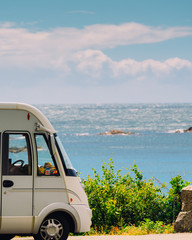 Camper car on coast of Norway with ocean view