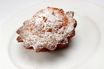 Tasty cupcake on a plate on a white isolated background