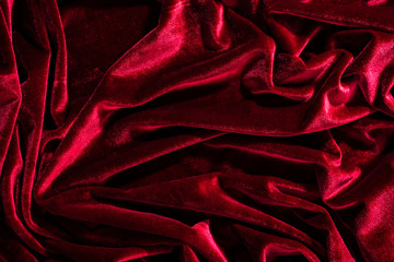 Background image of crumpled fabric. Red velvet