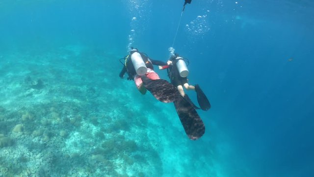 Child girl doing a scuba diving course in Gili Islands a world renown diving near Bali and Lombok Islands Indonesia.