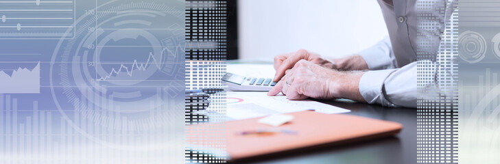 Senior businessman working on business report; panoramic banner