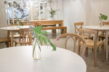 Fototapeta na wymiar Cozy coffee shop with wooden furniture set