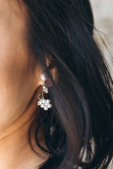 Closeup of a female ear with an earring.