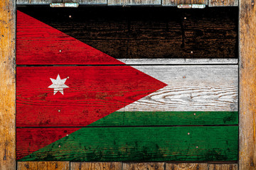 National flag of Jordan on a wooden wall background.The concept of national pride and symbol of the...
