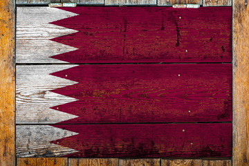 National flag of Qatar on a wooden wall background.The concept of national pride and symbol of the...