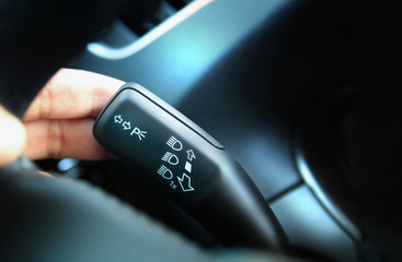 Close up on car headlight control lever used to select vehicle headlight mode
