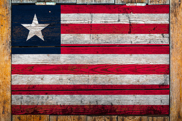 National flag of Liberia on a wooden wall background.The concept of national pride and symbol of...