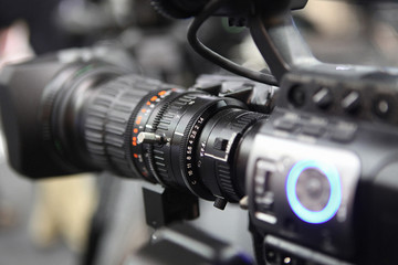 Plakat close up on media production video cameras in a recording studio ready for action