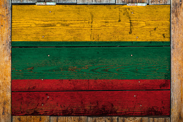 National flag of Lithuania on a wooden wall background.The concept of national pride and symbol of...