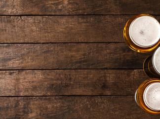 Beer glasses on wooden table with copyspace. - Powered by Adobe