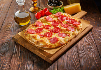 Flatbread pepperoni pizza on wooden board - obrazy, fototapety, plakaty
