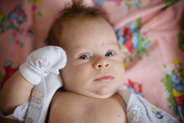 portrait of a baby lying on bed