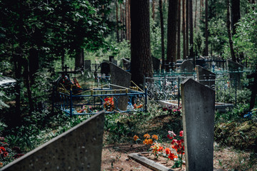 old christian cemetery with tombstones and crosses in a forest in europe former soviet union