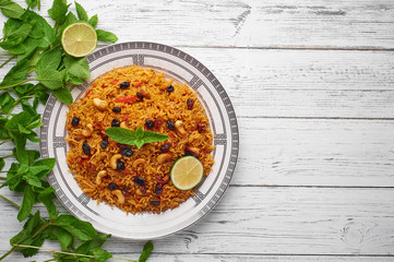 Vegetarian kabsa. Ramadan food. Kabsa is traditional saudi arabian cuisine dish. Kabsa cooks with basmati rice, spices, tomatoes, nuts and raisins. Copy space. Top View
