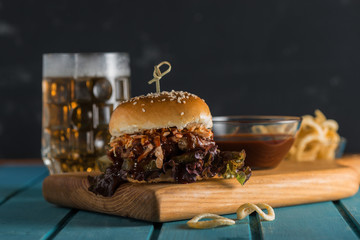 Burger Poulet with fried onions beer and barbecue sauce