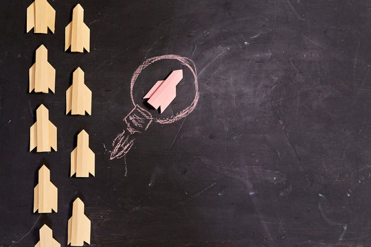 Business planning. Strategy. Challenge, improvment and progress concept. Red rocket leader on black background