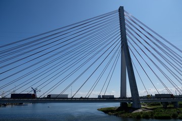 Fototapeta na wymiar Cable-stayed bridge on the Vistula river. Cars passing the bridge. Gdansk/Poland