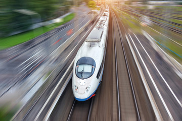 Railroad travel high speed fast train passenger locomotive motion blur effect in the city, top...