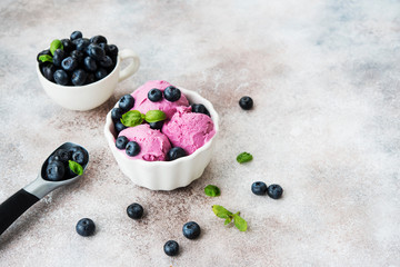 Homemade berry ice cream on a light concrete background. Copy space